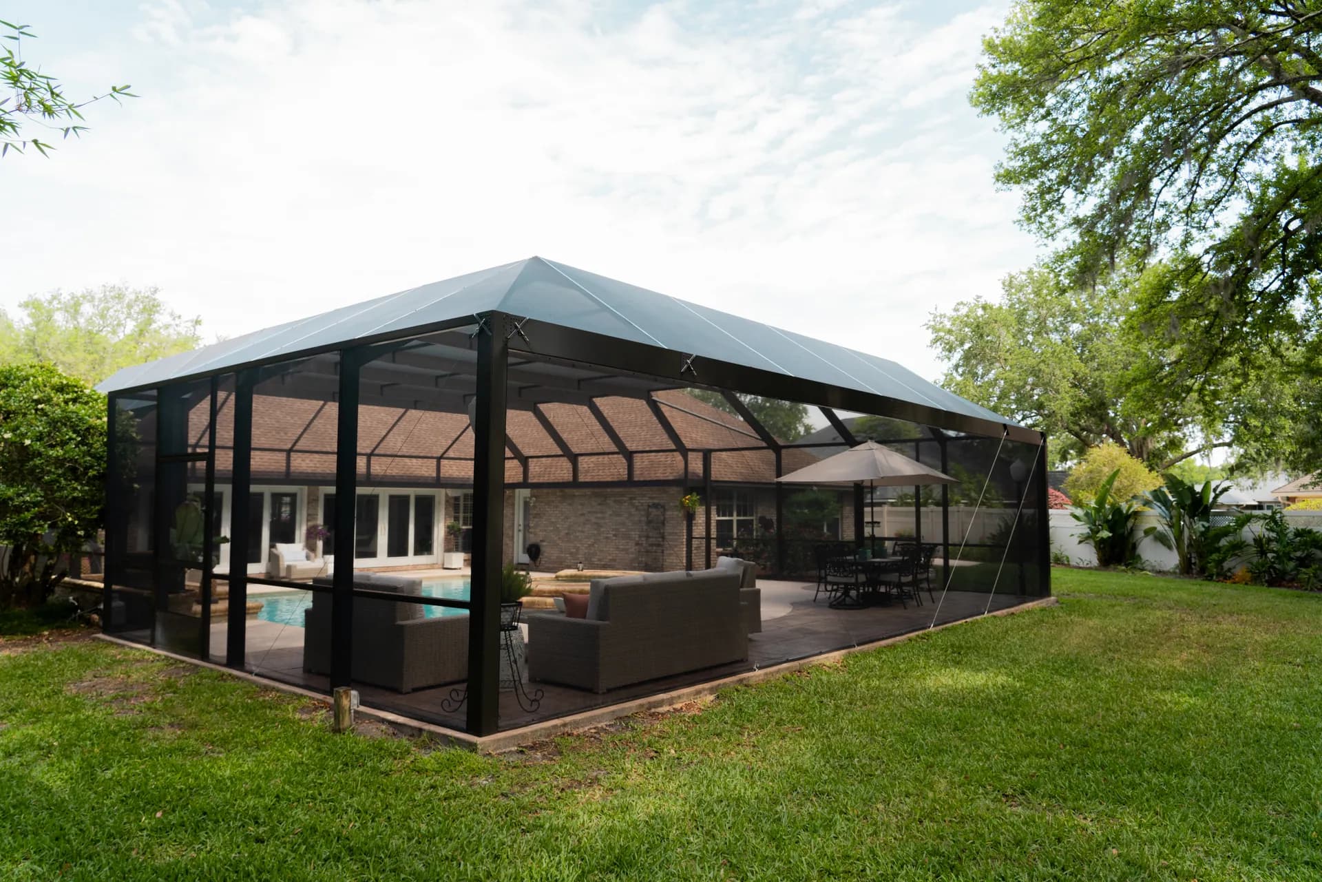 A large solid-roof enclosure covering a pool and patio