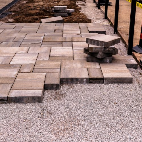 home construction: patio and walkway paving stone instalation in progress at a new house build in an older toronto residential neighbourhood room for text